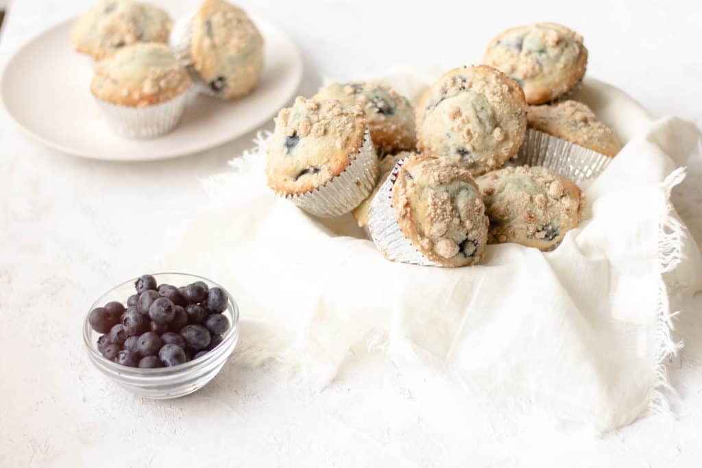 lots of blueberry muffins piled high in a bowl