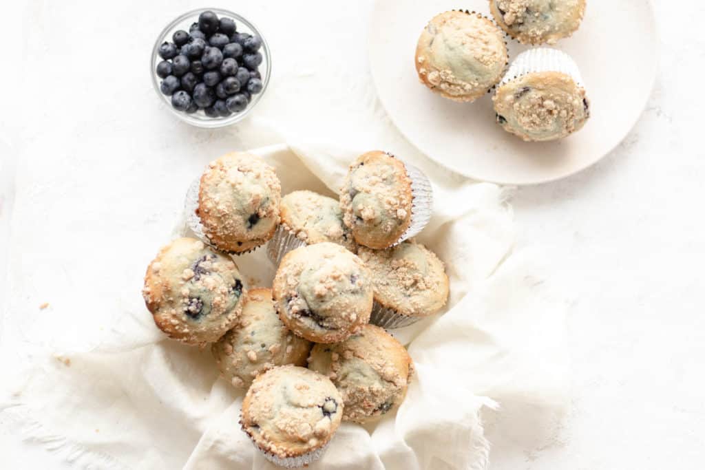 blueberry muffins in a bowl with a bowl of blueberries