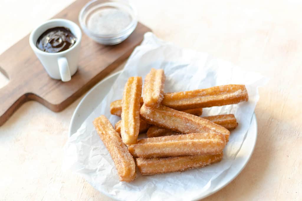 stacked churros on a plate