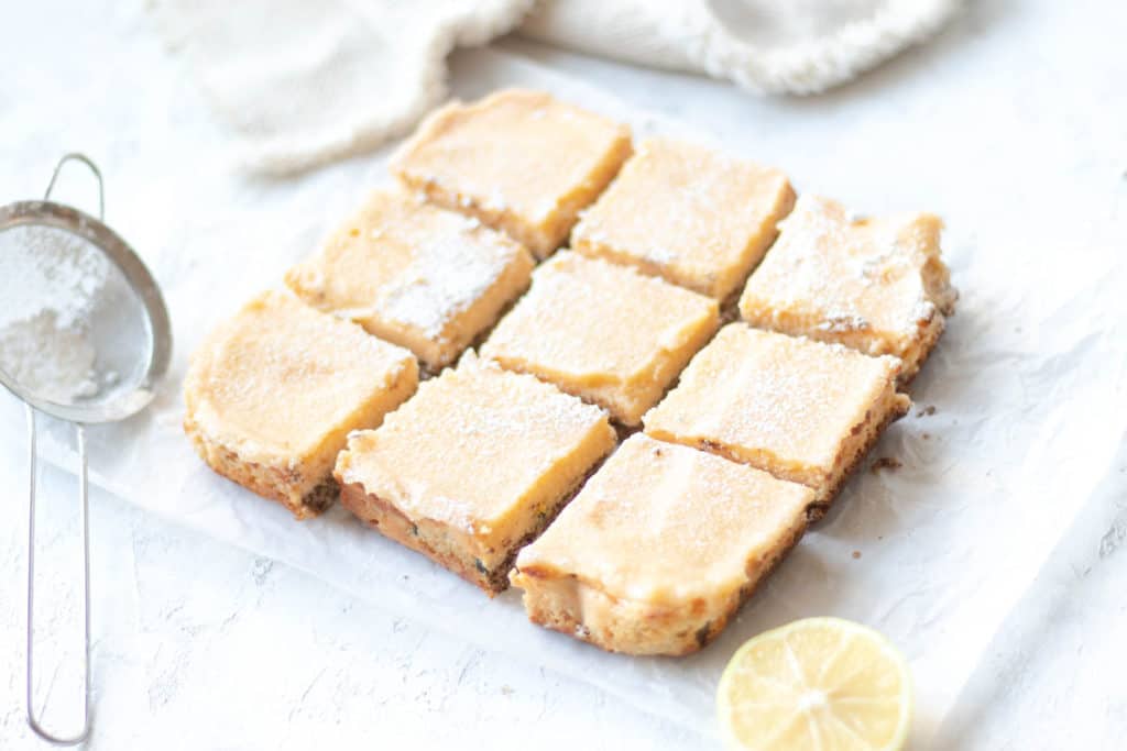 lemon passionfruit tart squares on parchment paper