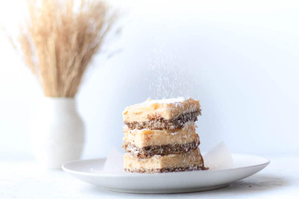 stack of passionfruit lemon bars with powdered sugar dusted on top