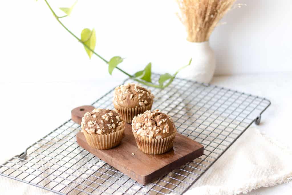 three coffee cake muffins on a mini cutting board