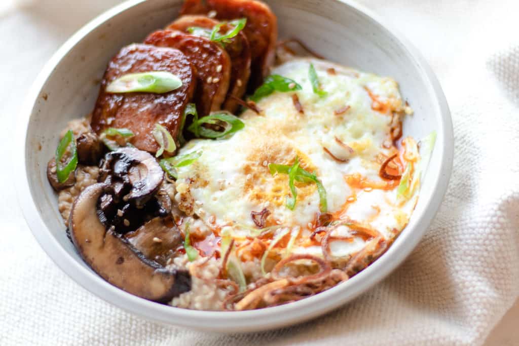 savory oats with spam, mushrooms, crispy onions, and an egg