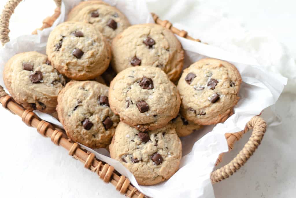 tahini cookies piled into a parchment lined basket