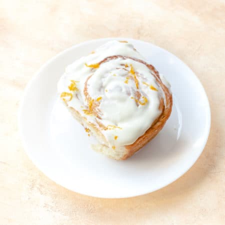 orange cinnamon roll on a round plate