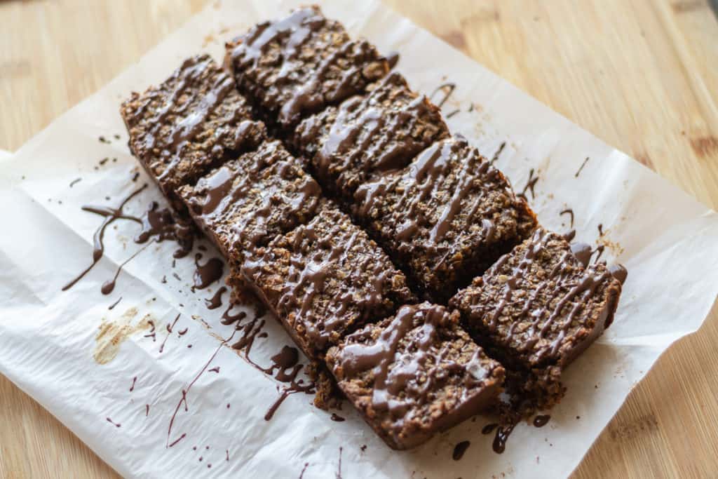 baked oatmeal bars with chocolate drizzled on top
