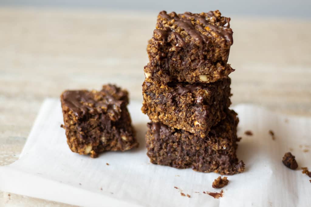 nutty chocolate oatmeal bars stacked on top of one another