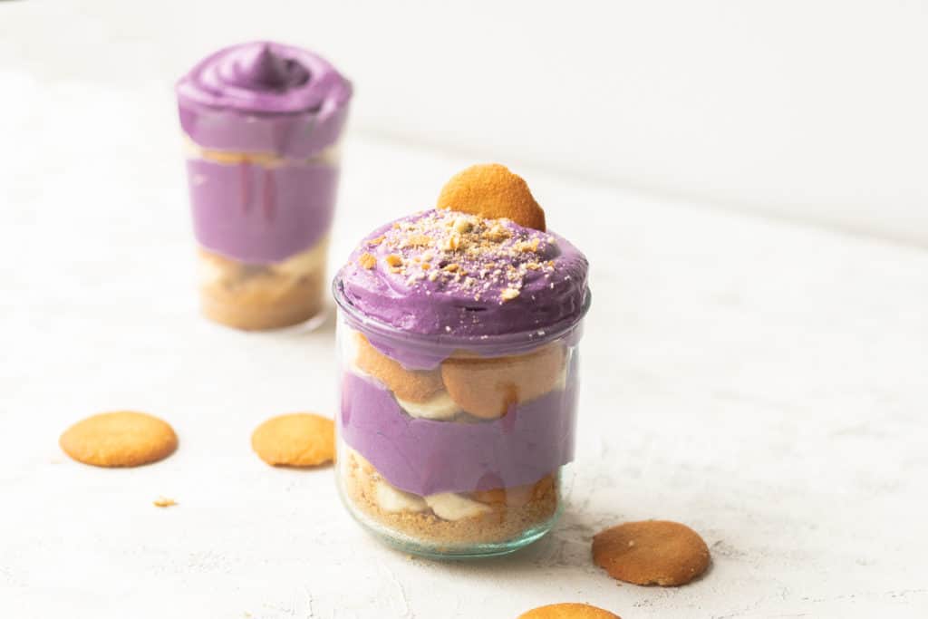 ube banana pudding with a nilla wafer cookie crumbled on top