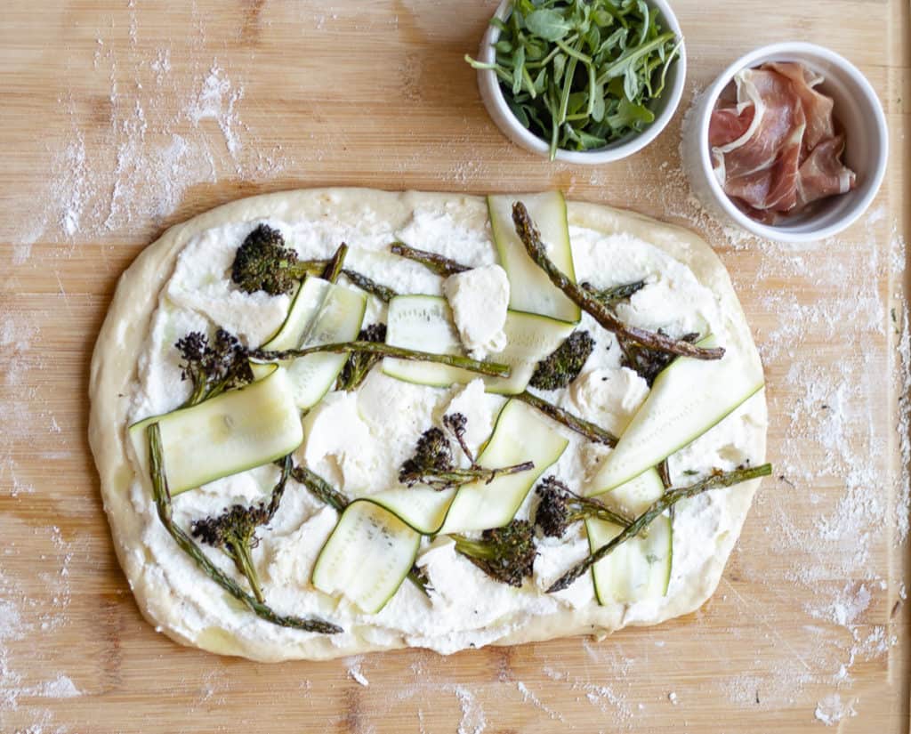 White pizza with zucchini ribbons, charred broccoli, and asparagus
