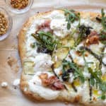 white pizza topped with spring vegetables