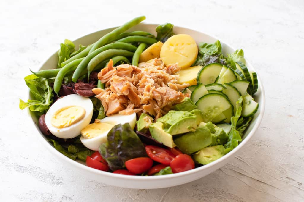 nicoise salad on a bed of greens
