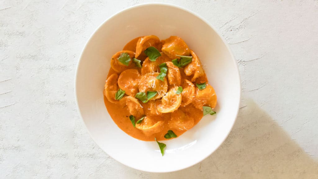 lobster tortellini with vodka sauce topped with parmesan and basil