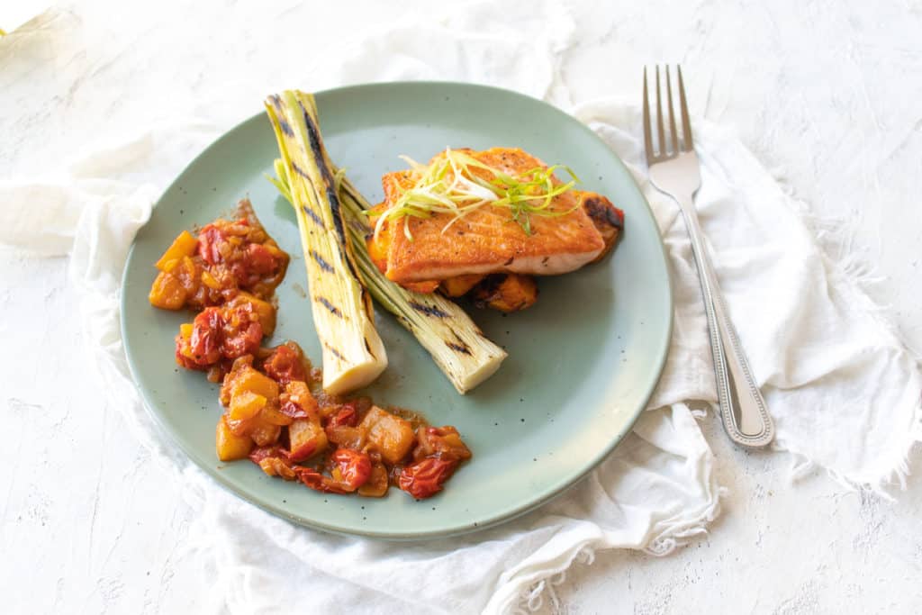 seared salmon with pineapple tomato sauce and charred leeks