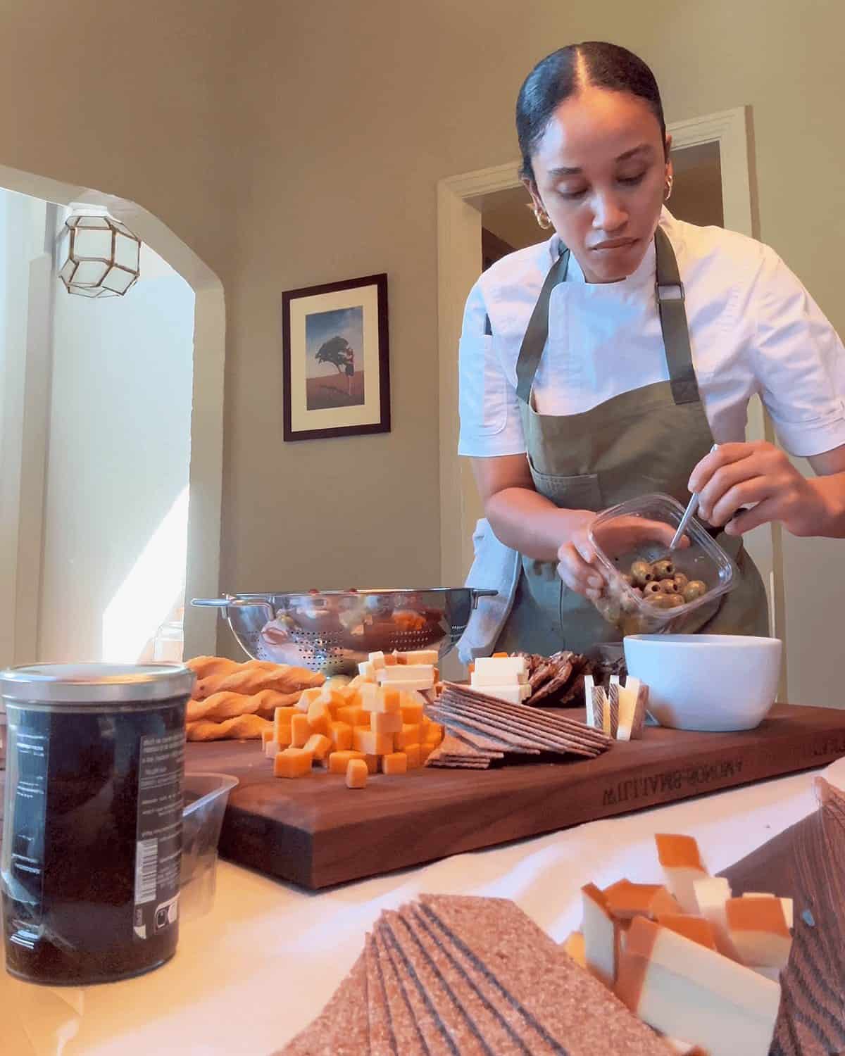 Nicole building a grazing board during an in-home event