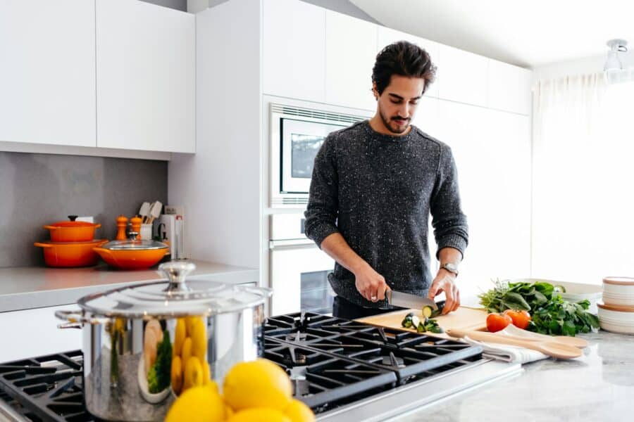 A chef cooking at the stove in a client’s home kitchen