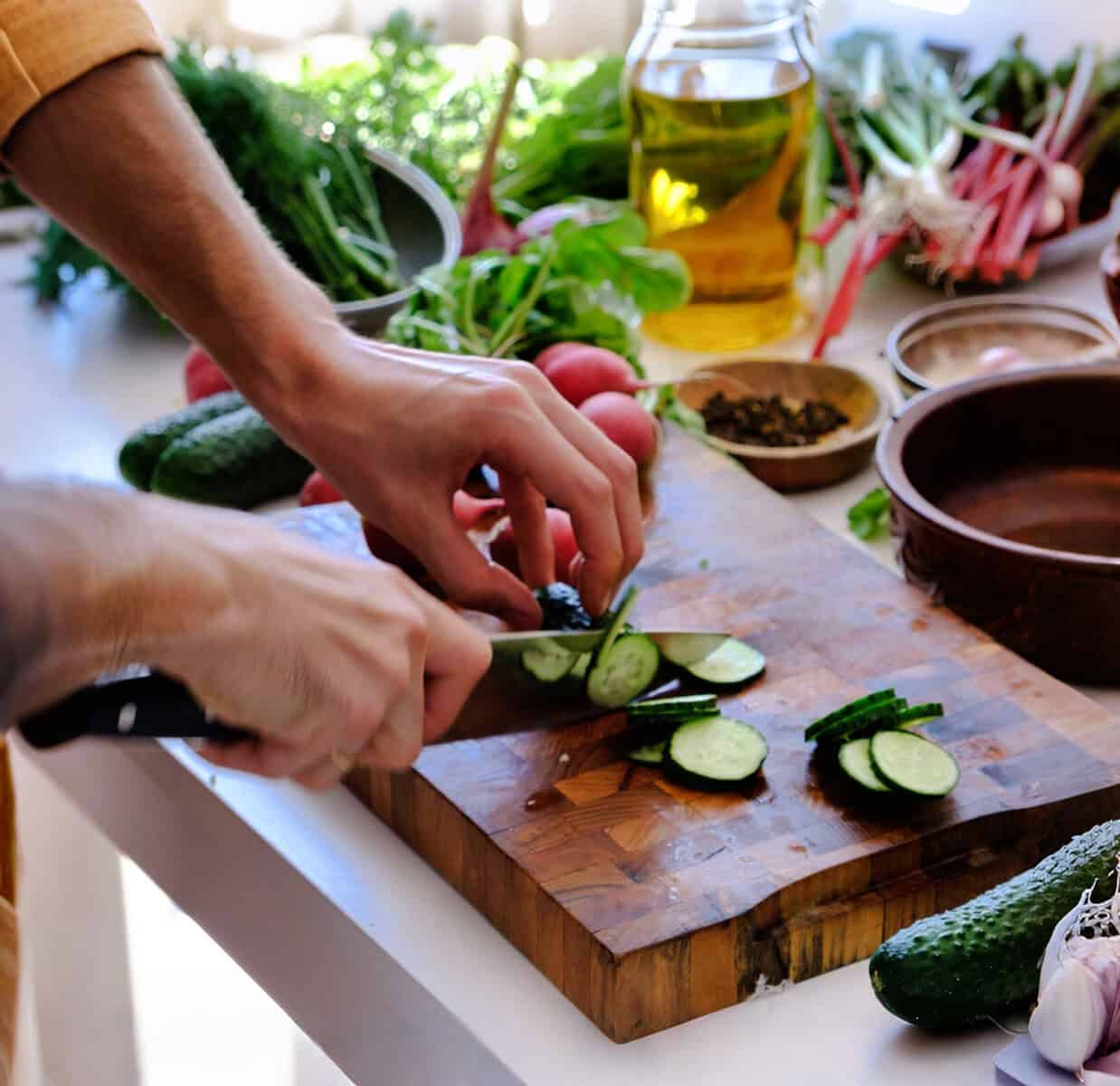 Fresh vegetables being prepped on a wooden cutting board